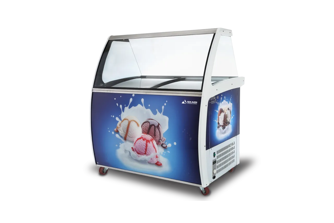 Curved Glass Ice Cream Freezer Display Unit | IDF with a sleek glass top and a front panel featuring an illustration of ice cream scoops splashing into milk, branded with Skadi logo.