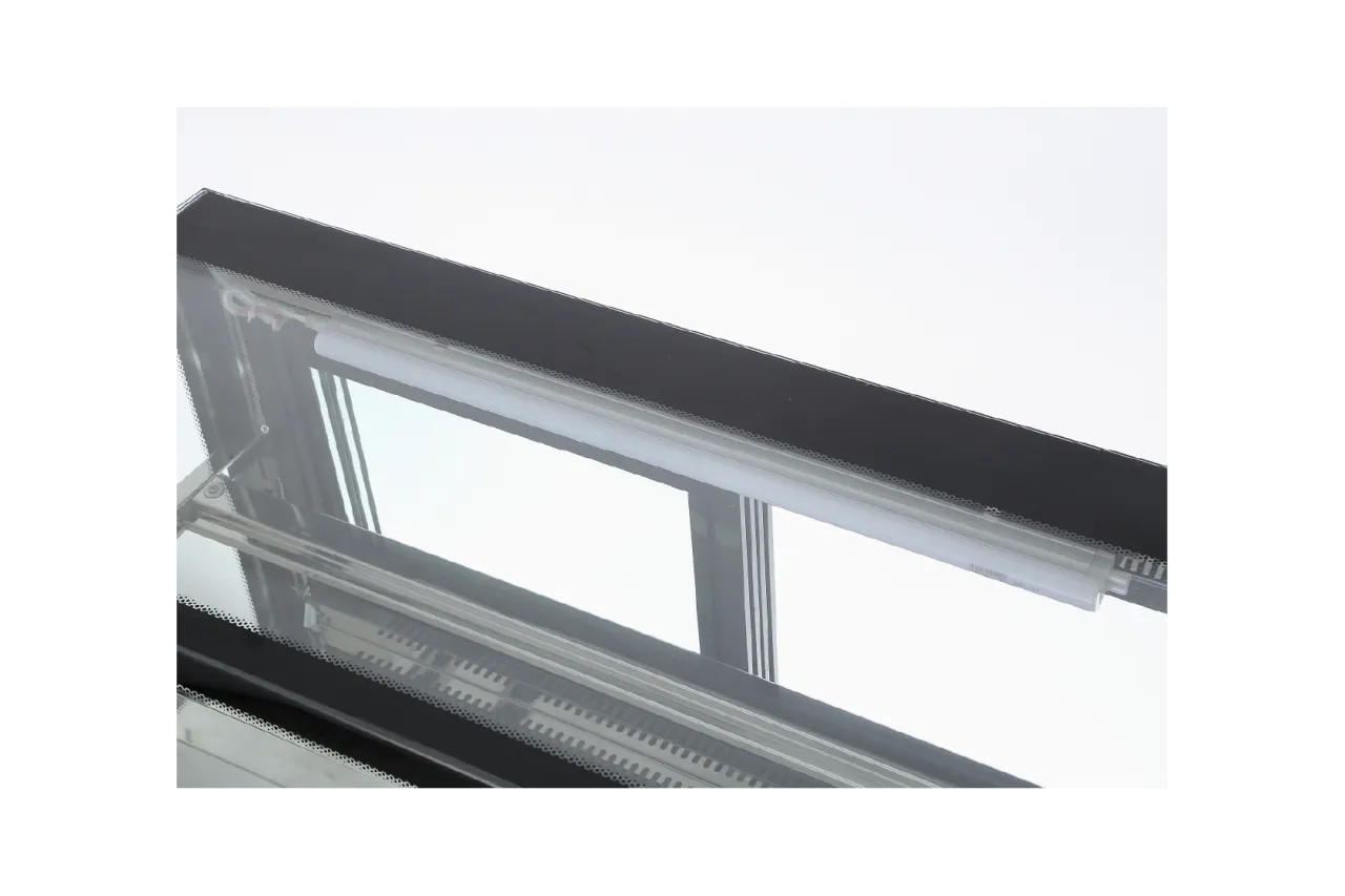 A close-up view of the top section of the [High-Visibility Countertop Cake Display Cabinet | CTD], showing the internal lighting fixture designed for optimal product illumination.