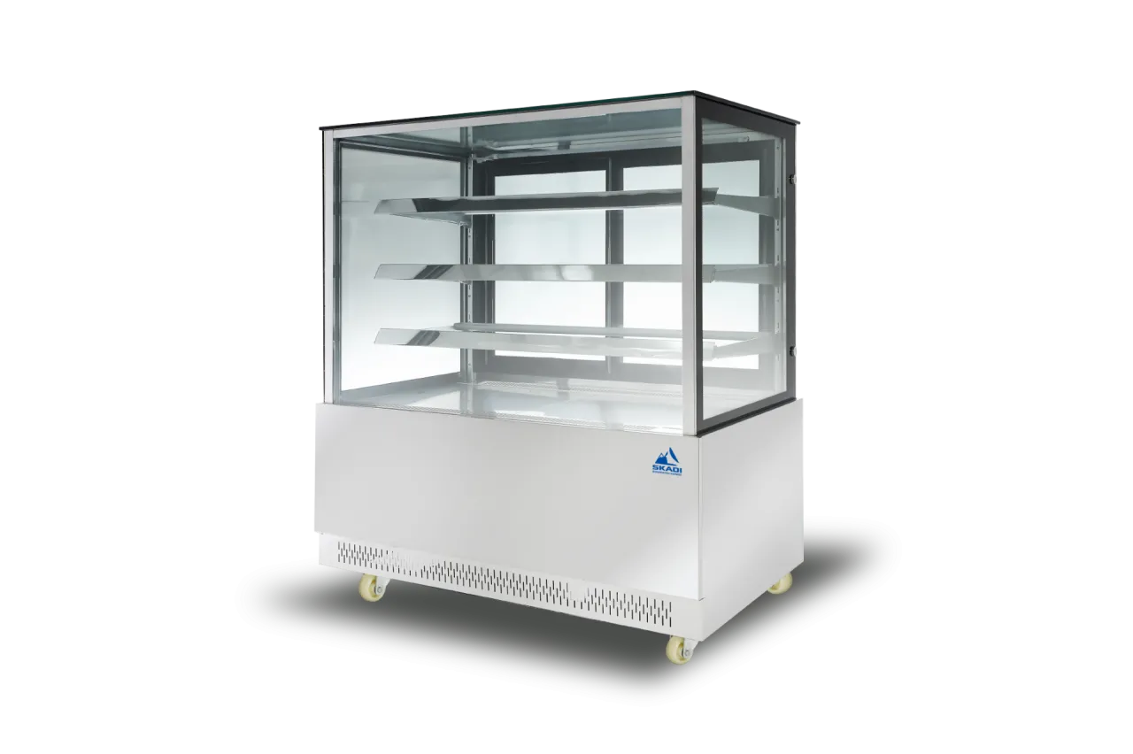 Image of a transparent glass cake display showcase with stainless steel exterior, multiple shelves, and a sleek design. The unit sits on wheels for easy mobility, part of the [Transparent Glass Cake Display Showcase | PNR-T] product line.