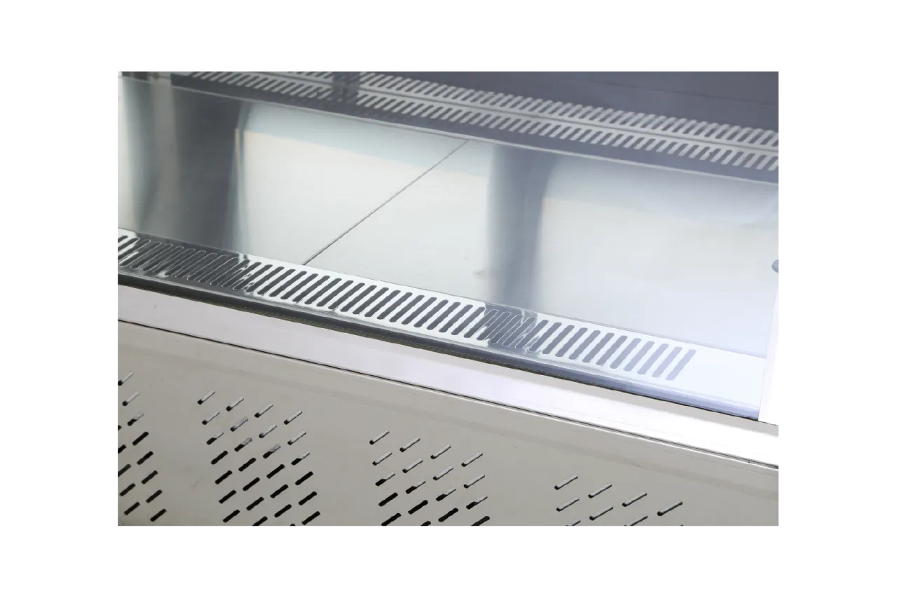 Close-up of the bottom shelf inside the [Panoramic Countertop Cake Display Showcase | CTSC085], showing a smooth metal surface and ventilation grilles.