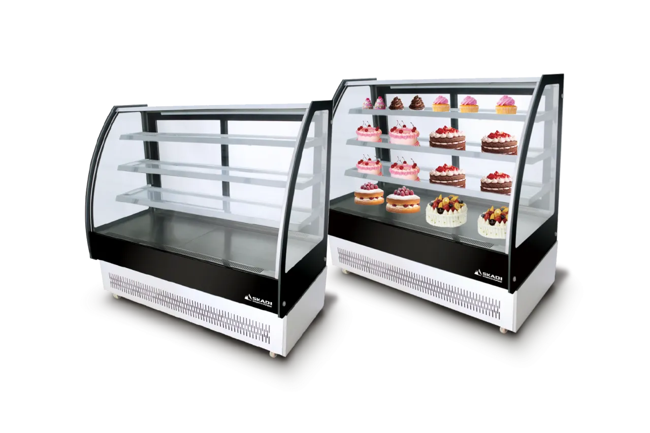 Two Full-View Curved Glass Pastry Display Showcase | ORC-T models side by side, one empty and one filled with cakes and pastries on the glass shelves.