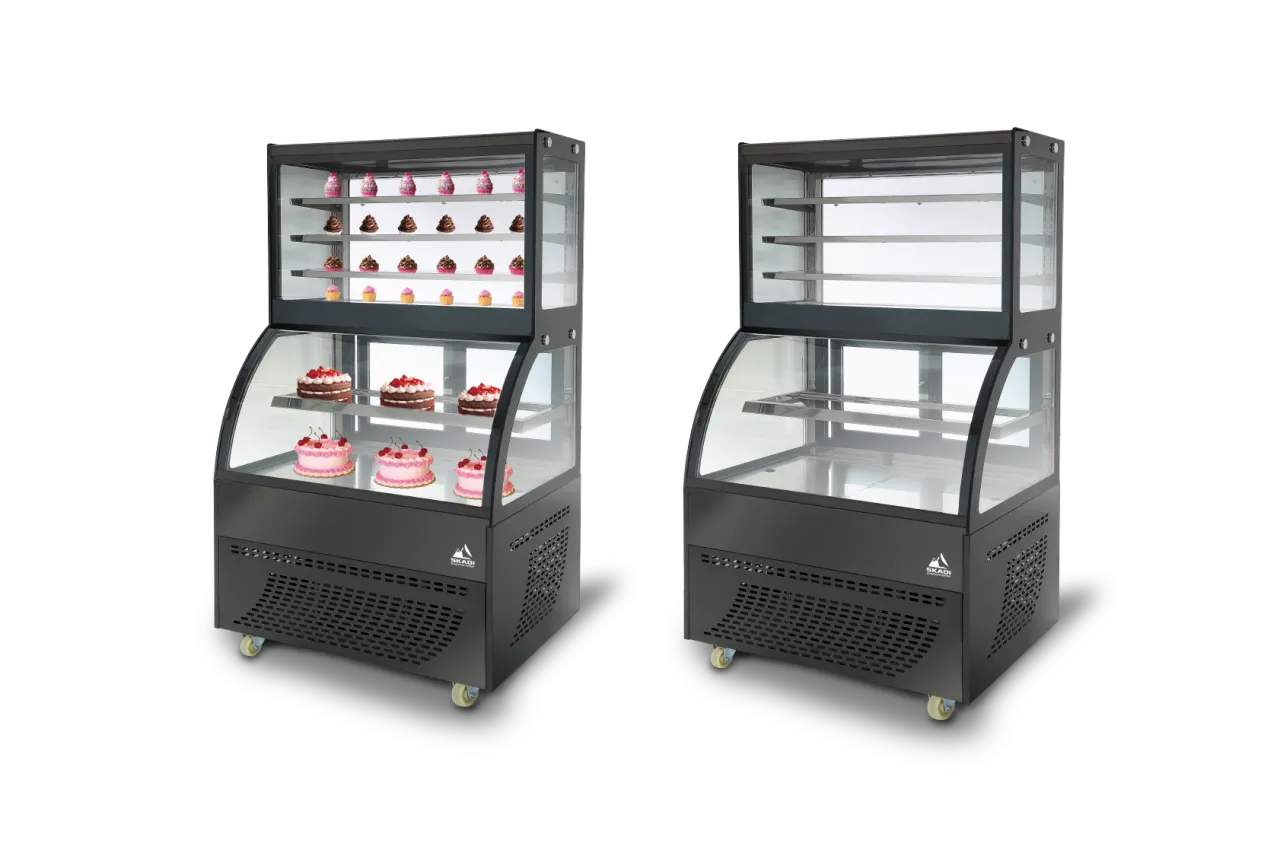 Two Compact Curved Glass Cake Display Cabinets | DXX side by side, one displaying a variety of cakes and the other empty, emphasizing the spacious interior and multiple shelving options for cake display.