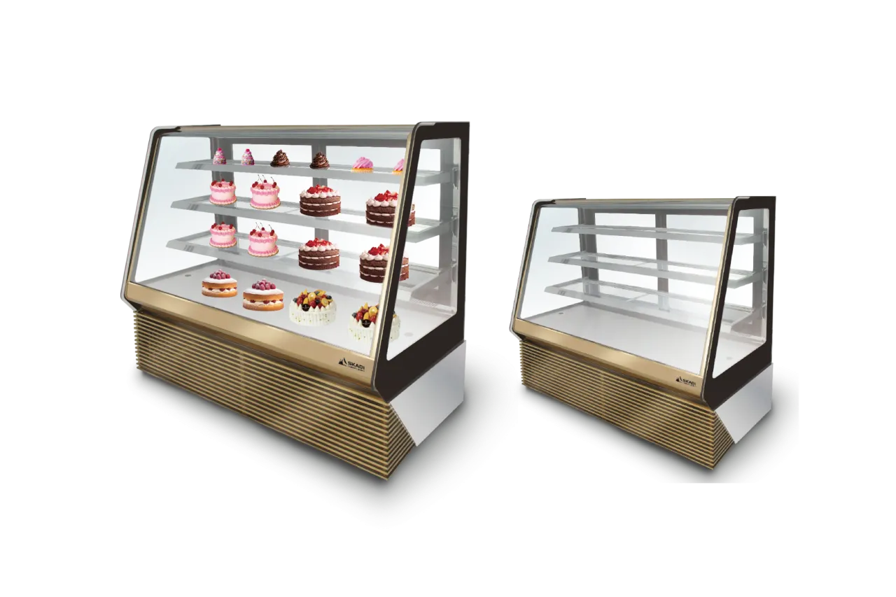 Two Luxurious Panoramic Cake Display Showcase | TLC-T models side by side, one filled with decorated cakes and the other empty. The showcases feature clear glass and a gold base for a luxurious touch.