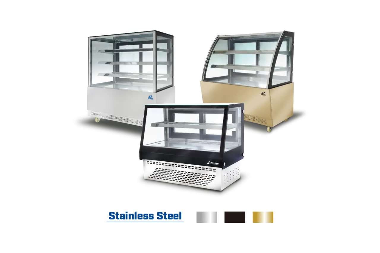 Three variations of the [High-Visibility Countertop Cake Display Cabinet | CTD] displayed in stainless steel, gold, and black finishes, showcasing different design styles and materials available.