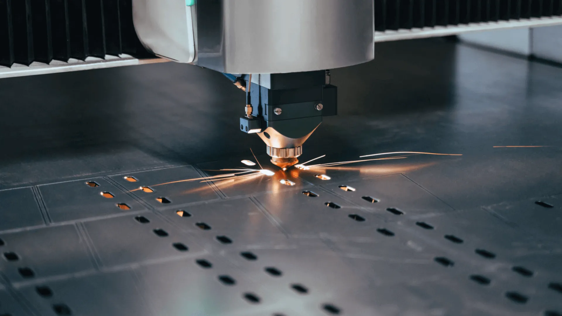 Image highlights a laser-cutting process in progress, showcasing intricate detail and craftsmanship for creating metal components used in premium cake display showcases.